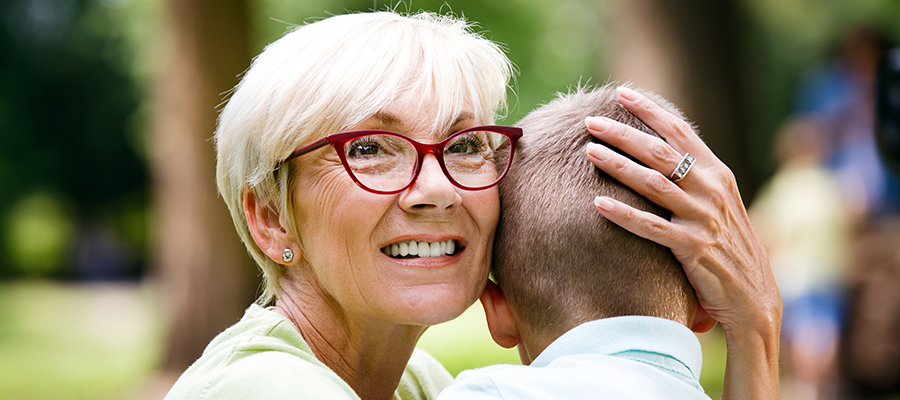 Happy grandmother with grandson together. Grandson hugs his grandmother