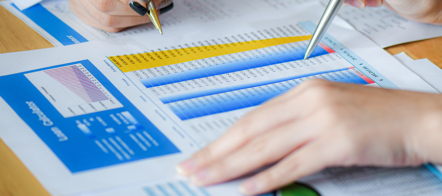 Female office staff are summarizing the number to present the executives.